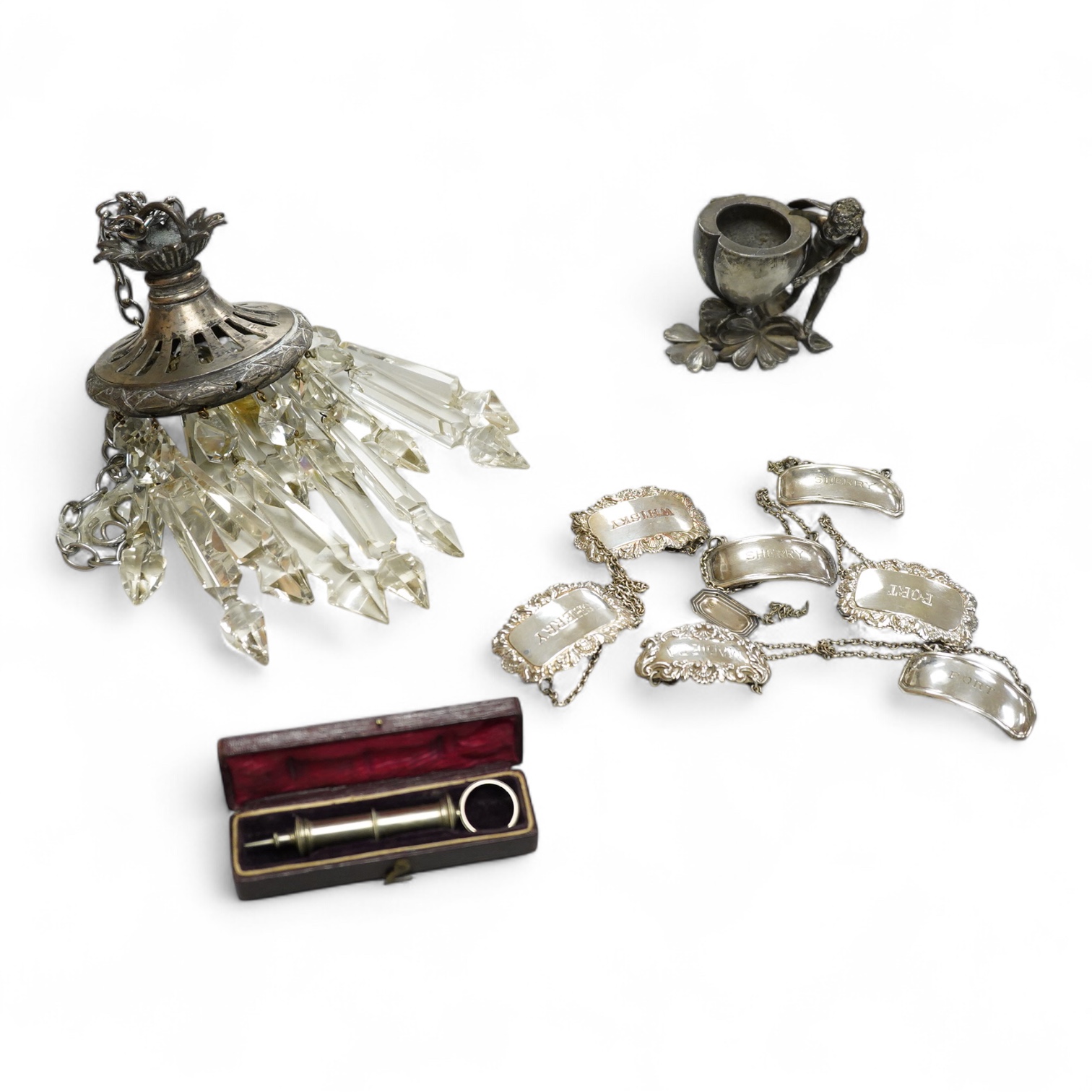 Sundry items to include a plated lustre drop hanging light, decanter labels and a small pot, mounted with a putti